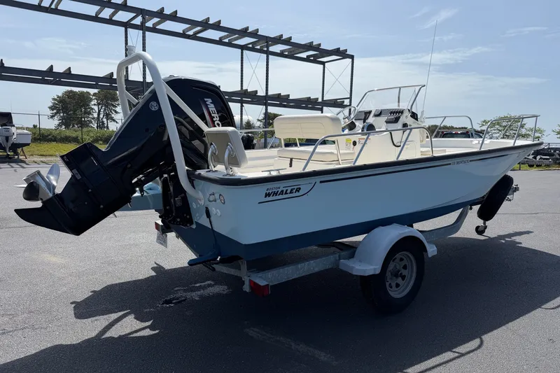 Slide: The Image of 2022 Boston Whaler 170 Montauk boat on trailer, parked outdoors. - 4