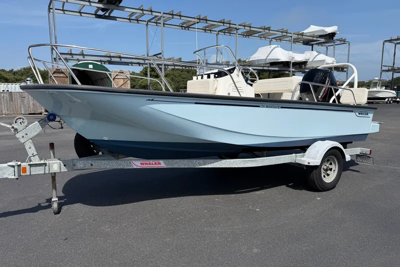 The Image of 2022 Boston Whaler 170 Montauk boat on trailer, parked outdoors. - 1