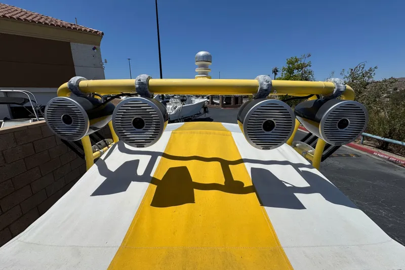 Slide: The Image of 2003 Centurion Cyclone C4 boat with mounted speakers on a sunny day. - 16