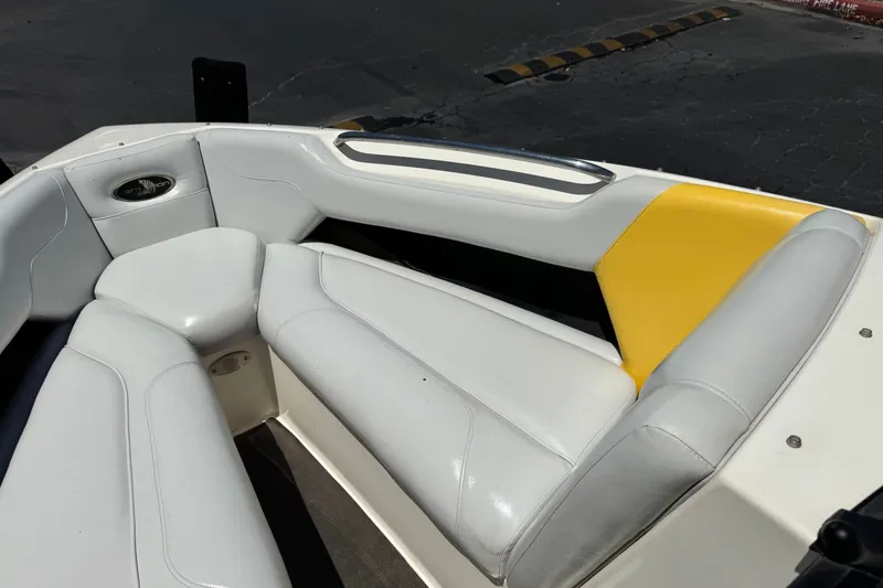 Slide: The Image of 2003 Centurion Cyclone C4 boat interior with white and yellow seating. - 13