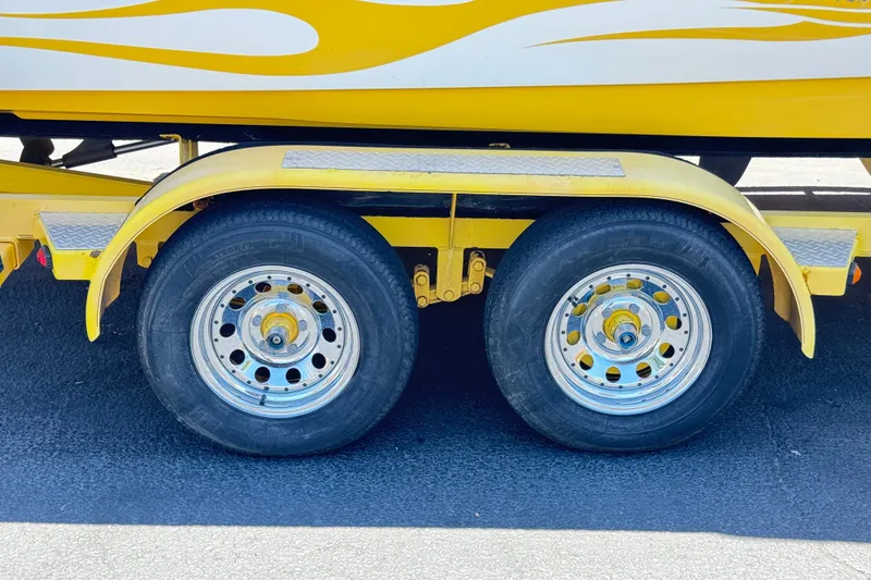 Slide: The Image of Yellow Centurion Cyclone C4 trailer with dual wheels, 2003 model. - 32