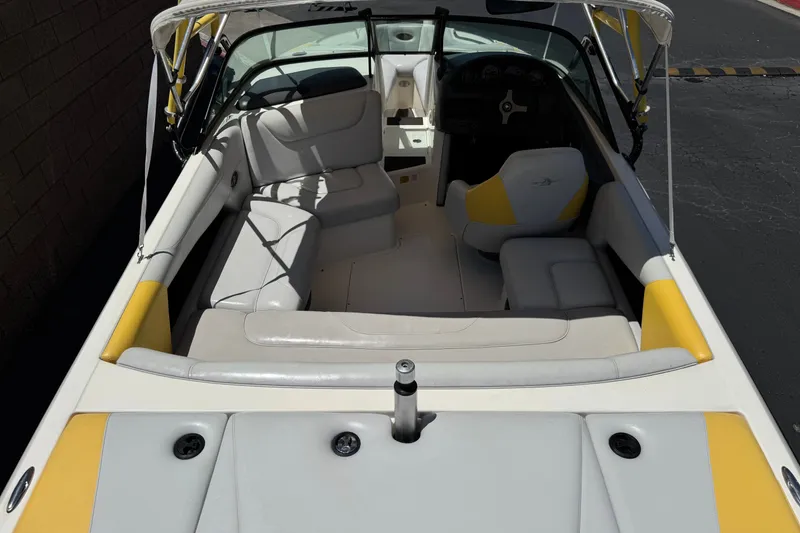 Slide: The Image of 2003 Centurion Cyclone C4 boat interior with white and yellow seating, steering wheel visible. - 8
