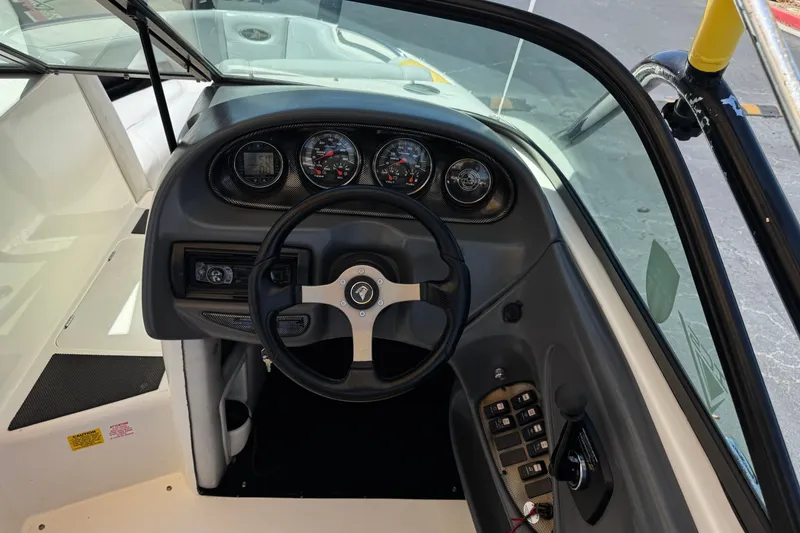 Slide: The Image of 2003 Centurion Cyclone C4 boat dashboard with steering wheel and instrument panel. - 28