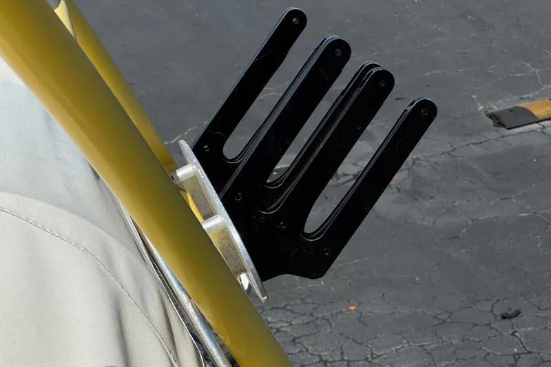 Slide: The Image of Wakeboard rack on a 2003 Centurion Cyclone C4 boat, mounted on a yellow tower. - 17