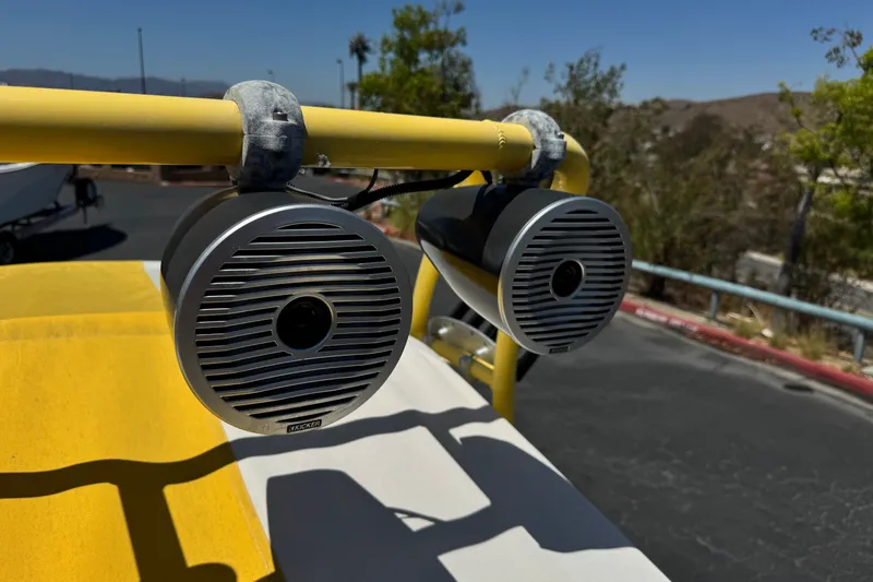 Slide: The Image of Close-up of Kicker speakers on a 2003 Centurion Cyclone C4 boat with yellow accents. - 18