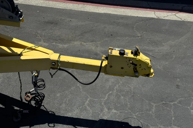 Slide: The Image of Yellow trailer hitch of a 2003 Centurion Cyclone C4 on asphalt pavement. - 33