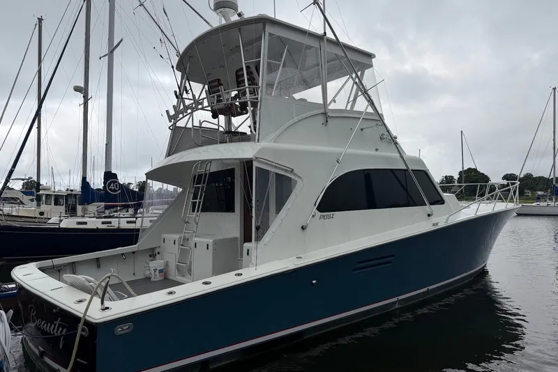 Slide: The Image of 1996 Post 50 Convertible yacht docked at marina on a cloudy day. - 5
