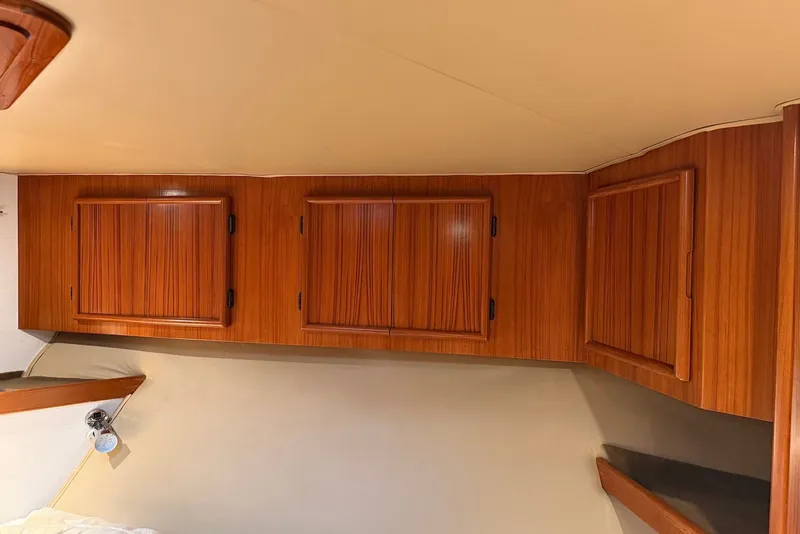 Slide: The Image of Wooden cabinets in a 1996 Post 50 Convertible boat interior. - 27