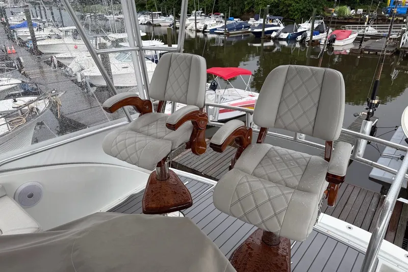 Slide: The Image of Luxurious seating on a 1996 Post 50 Convertible yacht, overlooking a marina. - 11