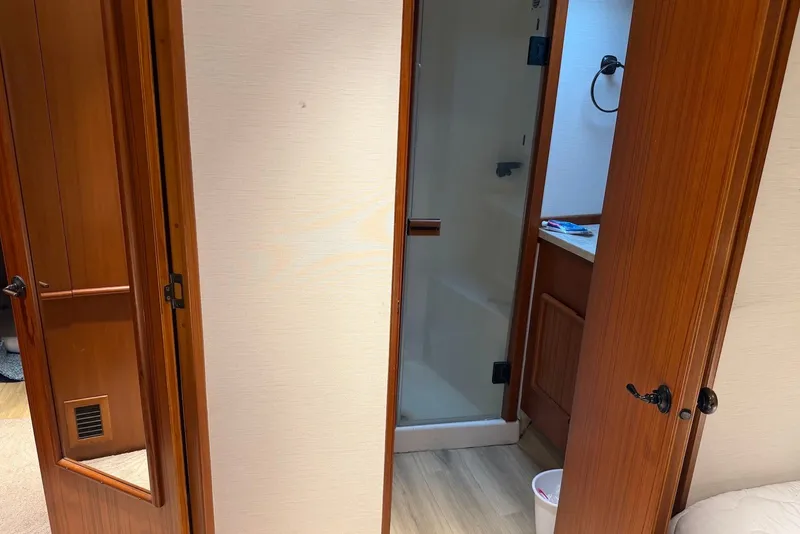 Slide: The Image of Interior of a 1996 Post 50 Convertible yacht showing a bathroom with wooden doors. - 36