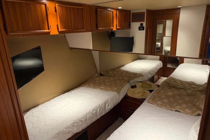 Slide: The Image of Luxurious 1996 Post 50 Convertible cabin with twin beds, wooden cabinets, and modern amenities. - 35