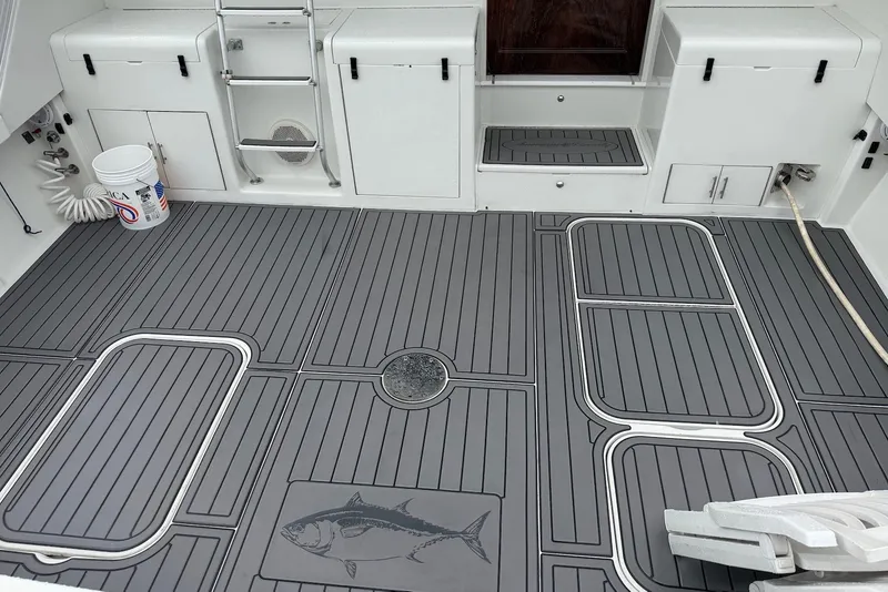 Slide: The Image of 1996 Post 50 Convertible boat deck with gray flooring and fish design. - 6