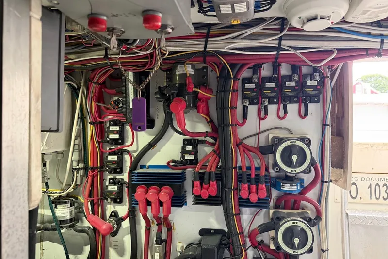 Slide: The Image of Electrical panel with wiring and switches in a 1996 Post 50 Convertible boat. - 44