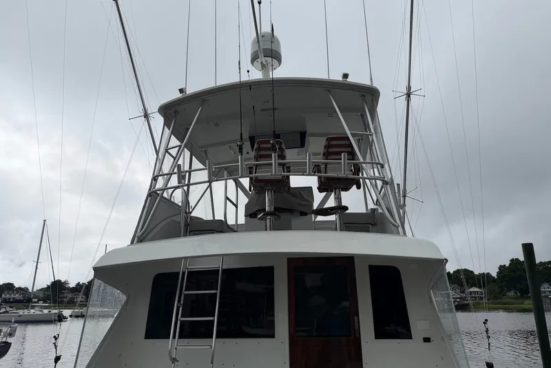 Slide: The Image of 1996 Post 50 Convertible yacht with upper deck, docked on a cloudy day. - 4
