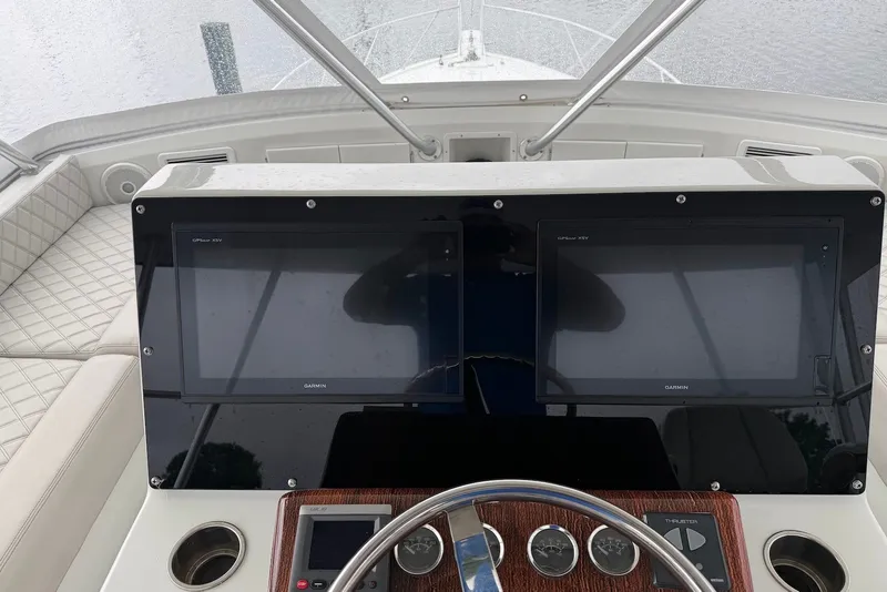 Slide: The Image of 1996 Post 50 Convertible boat dashboard with dual Garmin screens and steering wheel. - 13