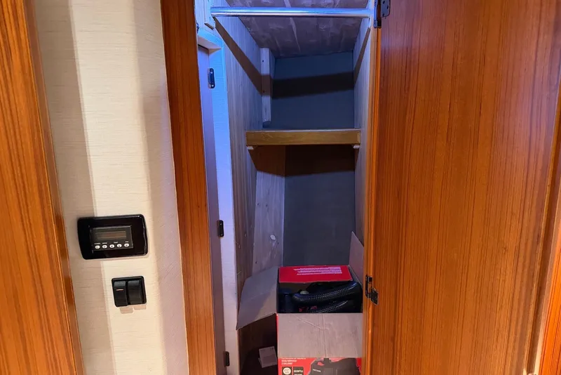 Slide: The Image of Wooden closet interior with shelves in a 1996 Post 50 Convertible boat. - 29
