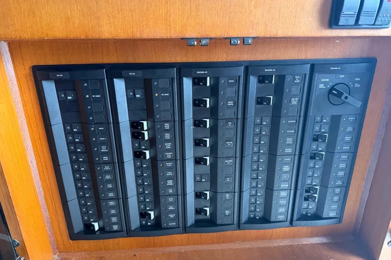 Slide: The Image of Electrical panel on a 1996 Post 50 Convertible boat, featuring multiple switches and controls. - 19