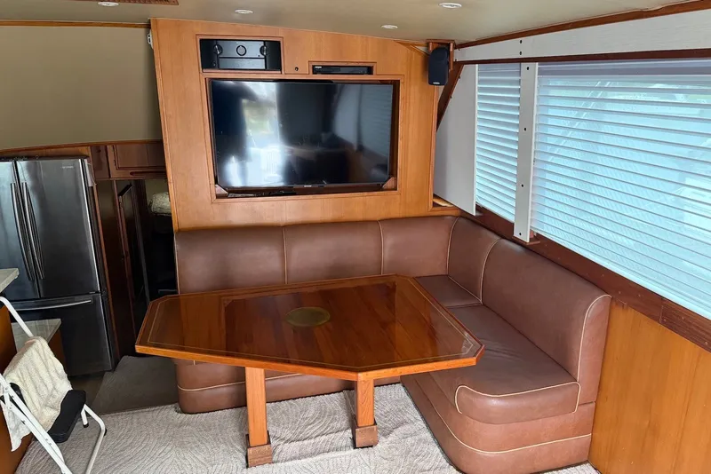 Slide: The Image of Interior of a 1996 Post 50 Convertible yacht with leather seating and a mounted TV. - 16