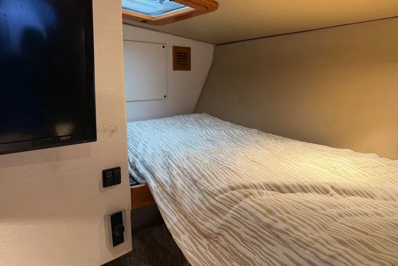 Slide: The Image of Interior cabin of a 1996 Post 50 Convertible yacht with bed and TV. - 32