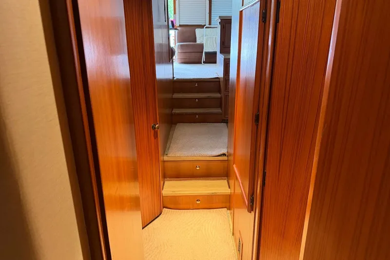Slide: The Image of Interior of 1996 Post 50 Convertible yacht with wooden paneling and carpeted stairs. - 23