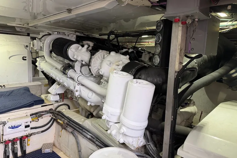 Slide: The Image of Engine room of a 1996 Post 50 Convertible yacht, showcasing detailed machinery and components. - 37