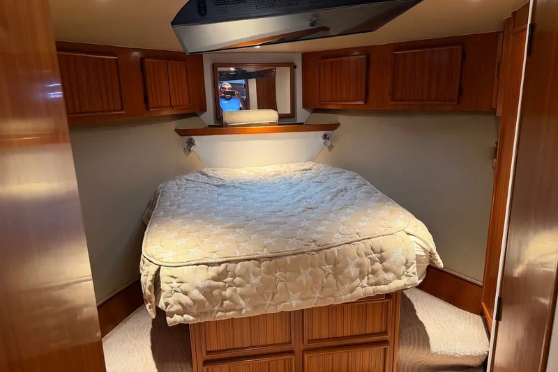 Slide: The Image of Cozy cabin interior of a 1996 Post 50 Convertible yacht with a comfortable bed. - 24
