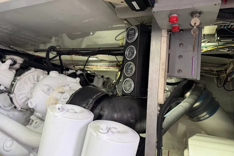 Slide: The Image of Engine room of a 1996 Post 50 Convertible yacht, showcasing gauges and mechanical components. - 42