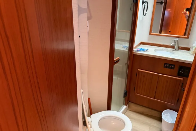 Slide: The Image of Bathroom interior of a 1996 Post 50 Convertible yacht, featuring wood cabinetry and modern fixtures. - 34