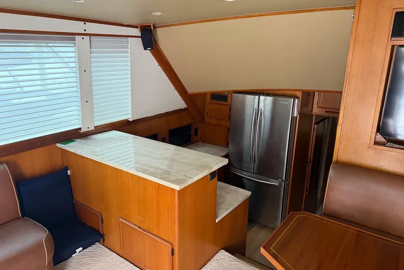 Slide: The Image of Interior of a 1996 Post 50 Convertible yacht with modern kitchen and stainless steel fridge. - 20