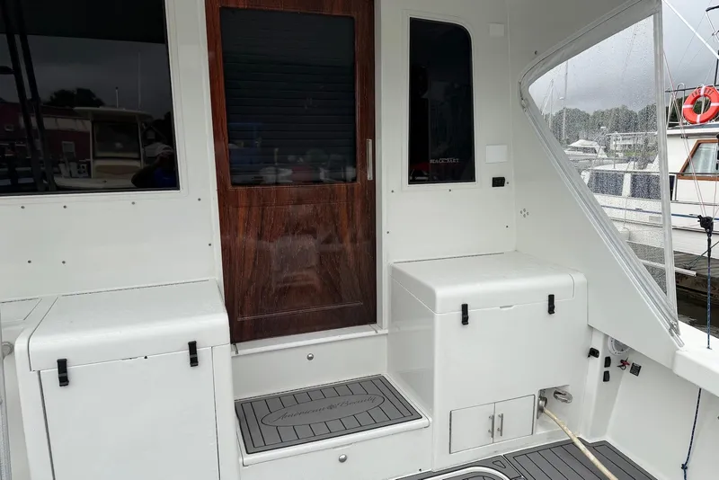 Slide: The Image of 1996 Post 50 Convertible yacht deck with wooden door and storage compartments. - 7