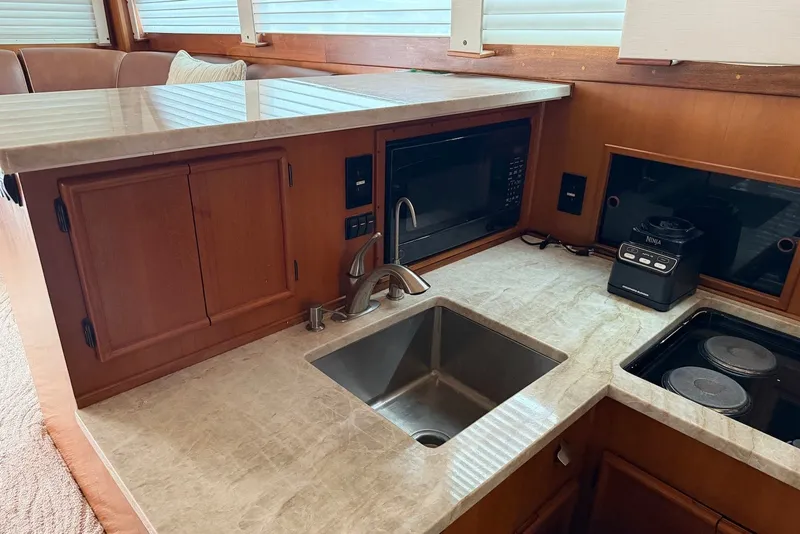 Slide: The Image of 1996 Post 50 Convertible yacht kitchen with sink, microwave, and blender on marble countertop. - 22