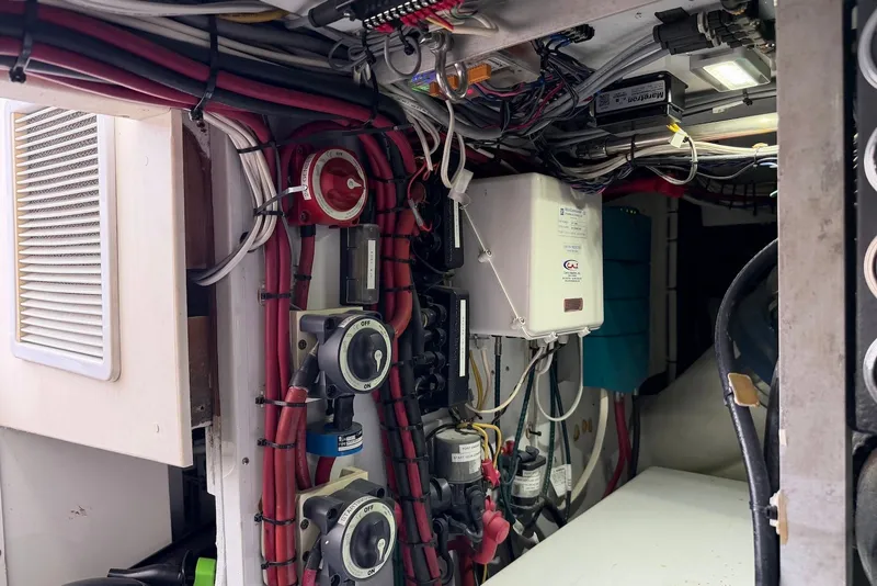 Slide: The Image of Engine room of a 1996 Post 50 Convertible boat with wiring and control panels. - 45
