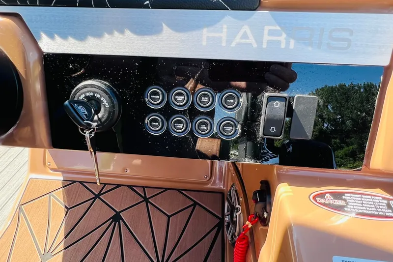 Slide: The Image of Control panel of 2027 Harris Grand Mariner 250 SL boat with ignition key and switches. - 20