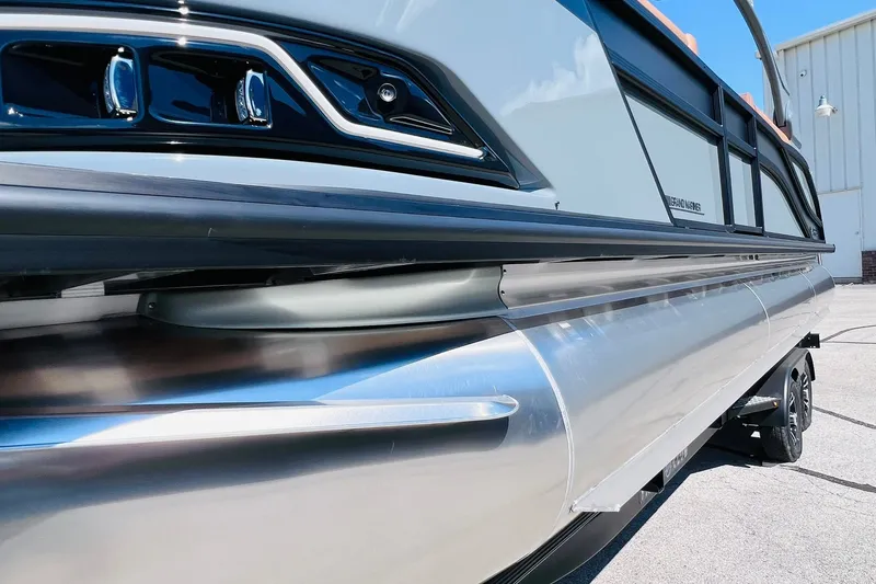 Slide: The Image of 2027 Harris Grand Mariner 250 SL pontoon boat, sleek design, close-up view. - 51