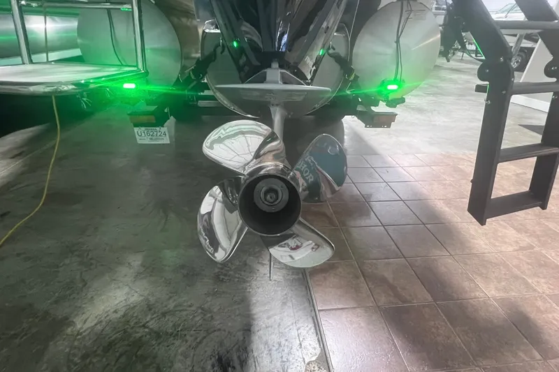 Slide: The Image of Propeller of 2027 Harris Grand Mariner 250 SL with green lights in a showroom. - 66