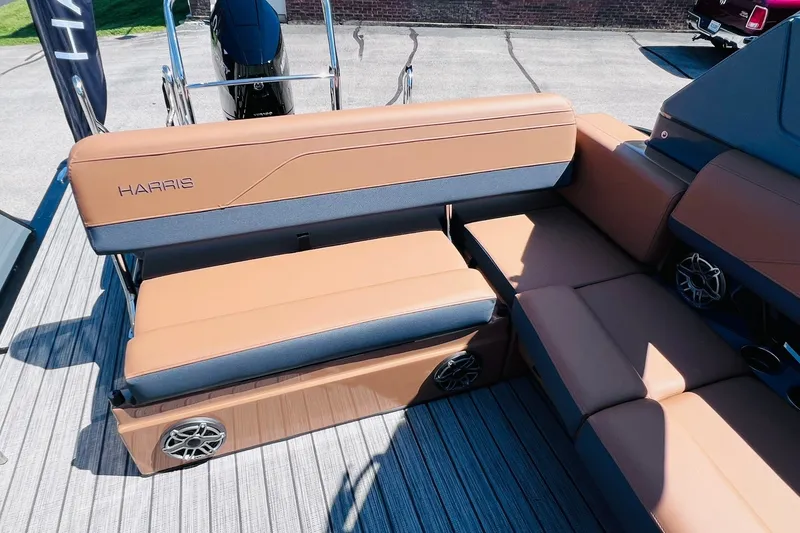 Slide: The Image of 2027 Harris Grand Mariner 250 SL boat interior with tan seating and integrated speakers. - 26