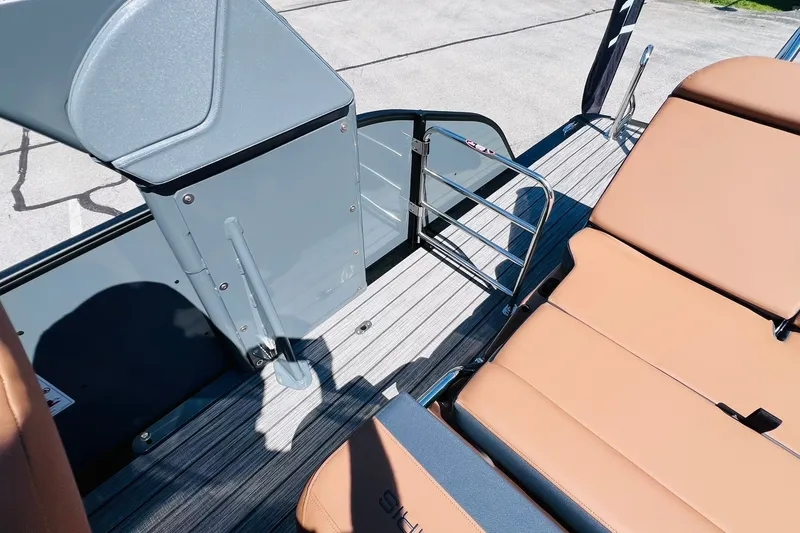 Slide: The Image of 2027 Harris Grand Mariner 250 SL boat interior with tan seating and sleek design. - 33