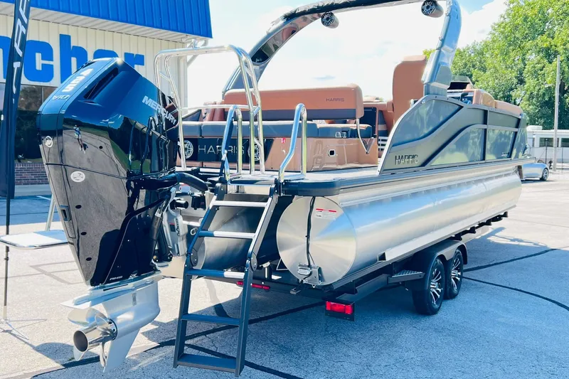 Slide: The Image of 2027 Harris Grand Mariner 250 SL pontoon boat with Mercury engine, parked outdoors. - 50