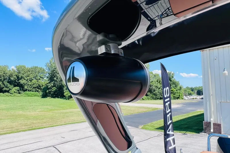 Slide: The Image of 2027 Harris Grand Mariner 250 SL with JL Audio speaker, outdoor setting. - 57