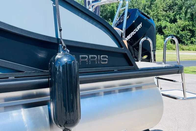 Slide: The Image of 2027 Harris Grand Mariner 250 SL pontoon boat with Mercury engine, docked outdoors. - 35