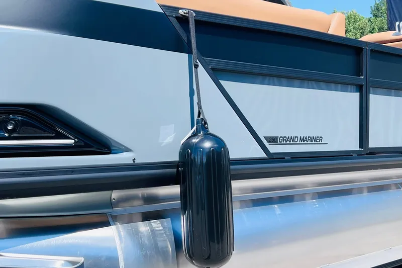 Slide: The Image of 2027 Harris Grand Mariner 250 SL pontoon boat with sleek design and black fender. - 34