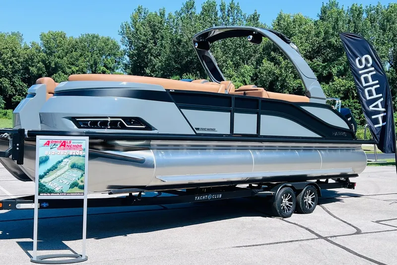 Slide: The Image of 2027 Harris Grand Mariner 250 SL pontoon boat on trailer, displayed outdoors. - 1