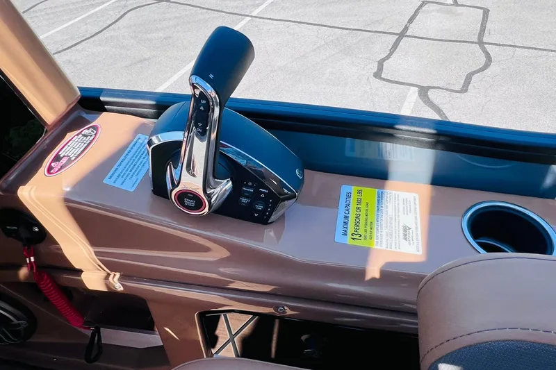 Slide: The Image of Control panel of 2027 Harris Grand Mariner 250 SL boat with throttle and cup holder. - 21
