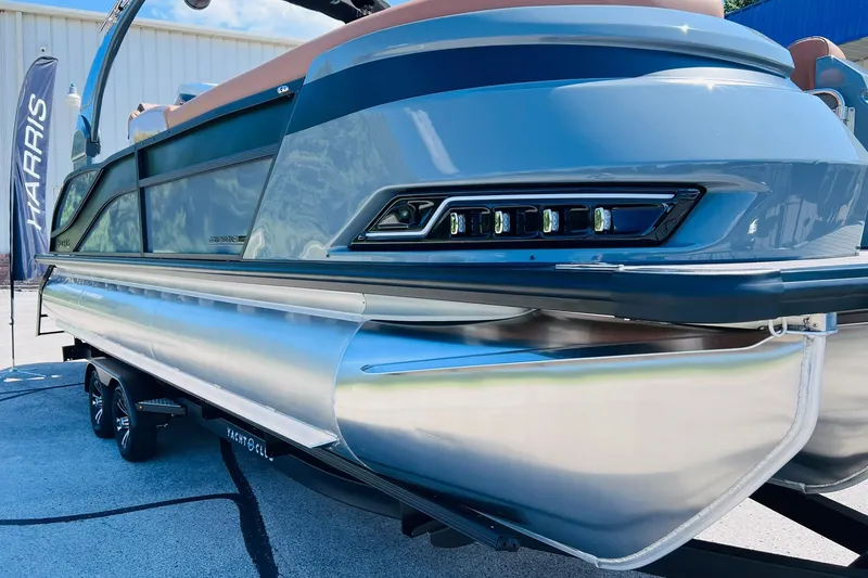 Slide: The Image of 2027 Harris Grand Mariner 250 SL pontoon boat on trailer, showcasing sleek design and modern features. - 54