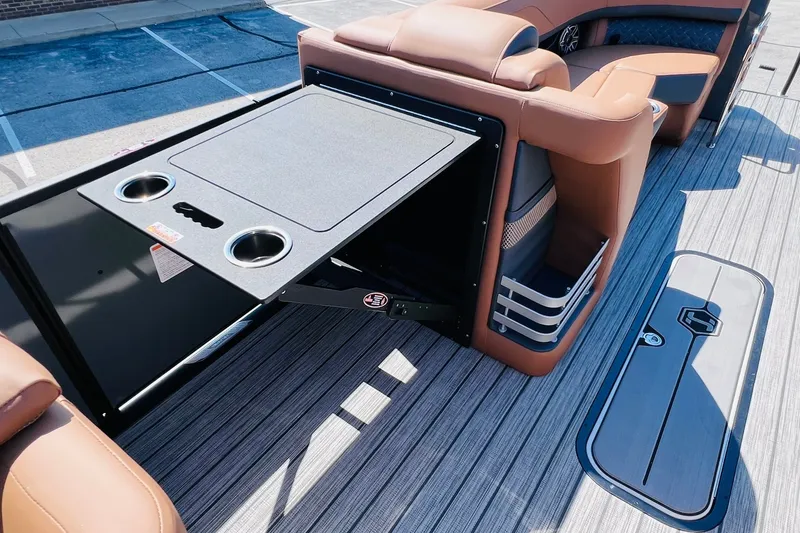 Slide: The Image of 2027 Harris Grand Mariner 250 SL boat interior with table and cup holders. - 23