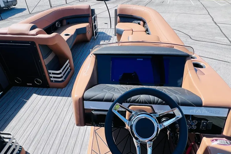 Slide: The Image of Interior view of 2027 Harris Grand Mariner 250 SL pontoon boat with luxurious seating and modern dashboard. - 13