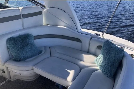 Slide: The Image of Luxurious seating area on a 2006 Sea Ray Sundancer 320 yacht with blue cushions. - 9