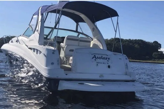 Slide: The Image of 2006 Sea Ray Sundancer 320 boat on water, rear view with canopy and seating. - 2
