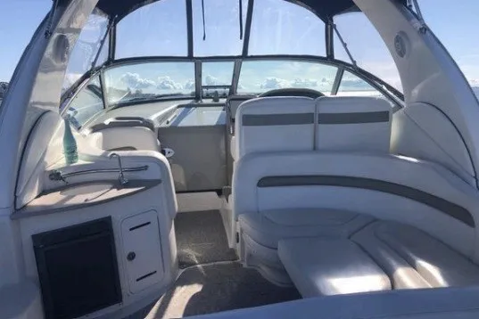 Slide: The Image of 2006 Sea Ray Sundancer 320 interior with plush seating and panoramic windows. - 5