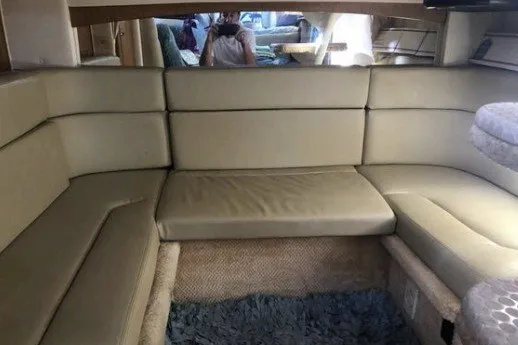 Slide: The Image of Interior of 2006 Sea Ray Sundancer 320 with beige seating and carpeted floor. - 16